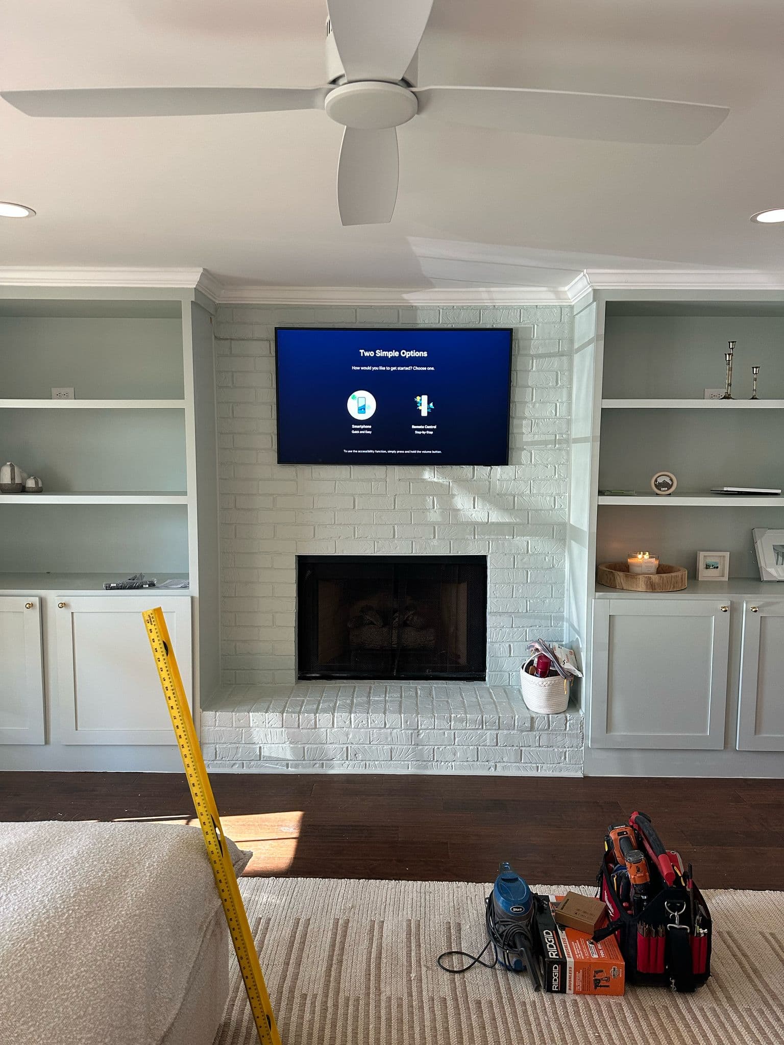Technician mounting a TV with clean cable finish