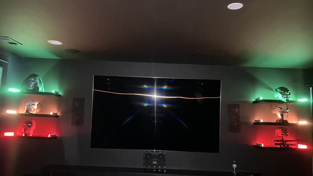 Mounted home theater TV with surround speakers and LED floating shelves in a media room, Nashville TN